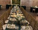 Greenery, tablecloths, napkins, utensils, glasses, and name cards all by Delta Party.